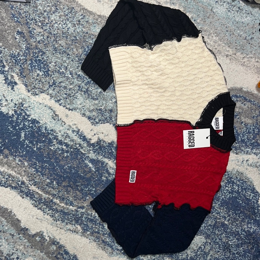 ragged priest red, black, white, and blue sweater